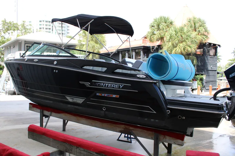 Slide: The Image of 2021 Monterey 255SS Super Sport boat on display, featuring sleek black design and canopy. - 7