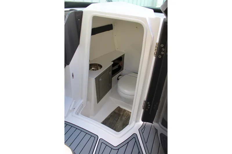 Slide: The Image of Interior of 2021 Monterey 255SS Super Sport boat bathroom with toilet and sink. - 29