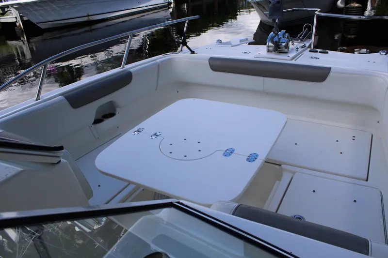 Slide: The Image of 2021 World Cat 255 DC boat interior with seating and table setup. - 20