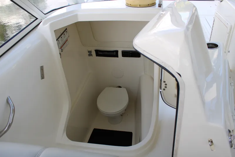 Slide: The Image of Interior view of a 2021 World Cat 255 DC boat's compact marine toilet area. - 31