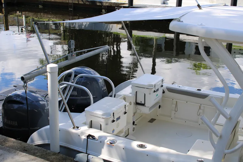 Slide: The Image of 2021 World Cat 255 DC boat with Yamaha engines docked by the water. - 37