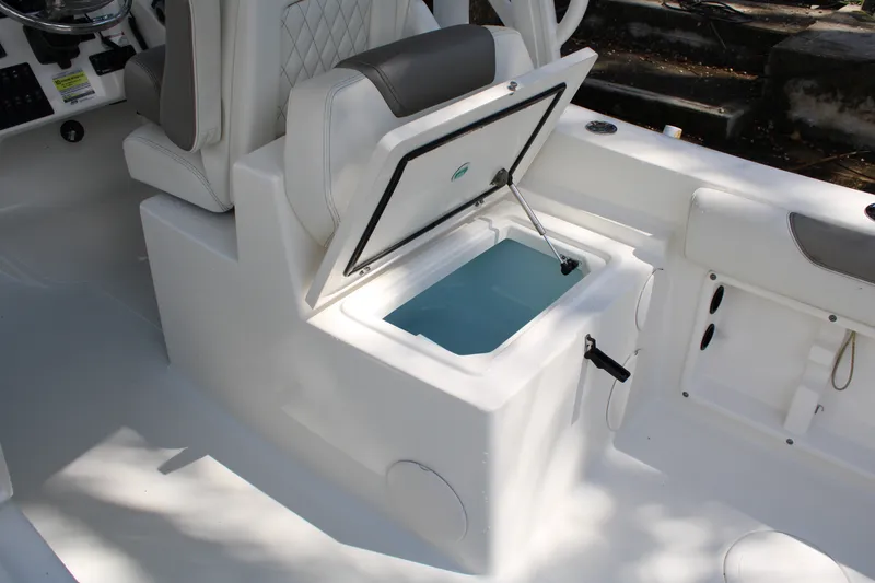 Slide: The Image of 2021 World Cat 255 DC boat interior with open storage compartment. - 24