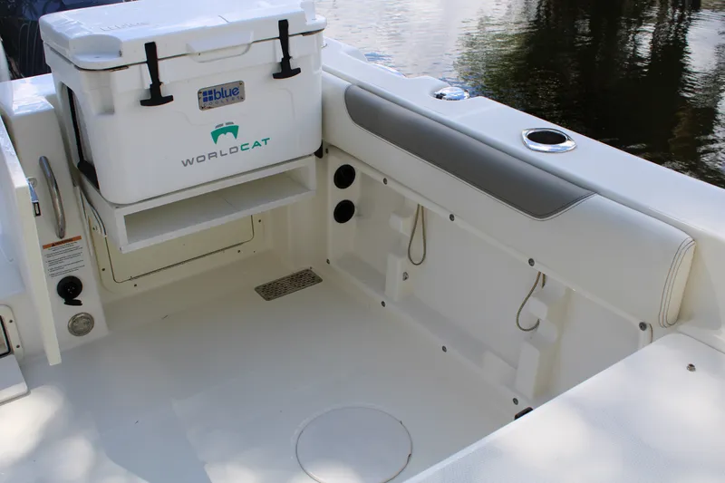 Slide: The Image of 2021 World Cat 255 DC boat interior with cooler and seating area. - 28