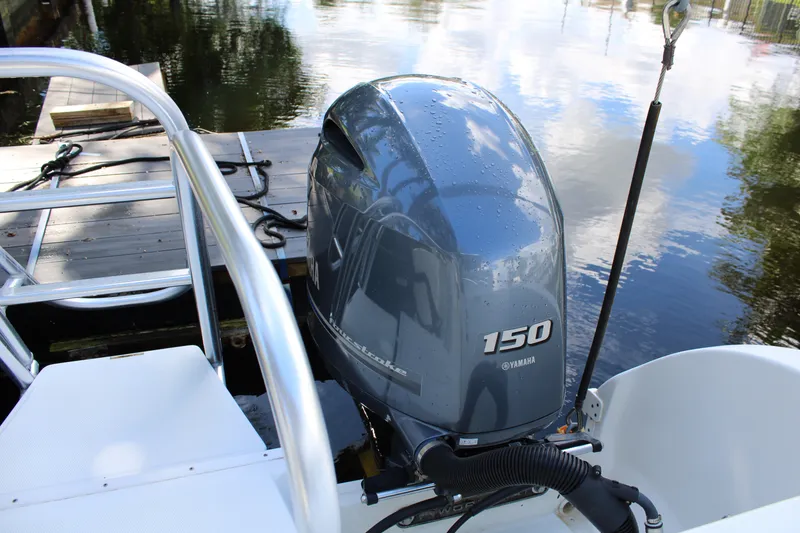 Slide: The Image of Yamaha 150 outboard motor on a 2021 World Cat 255 DC boat by a dock. - 35