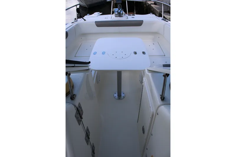 Slide: The Image of 2021 World Cat 255 DC boat interior with table and seating area. - 19