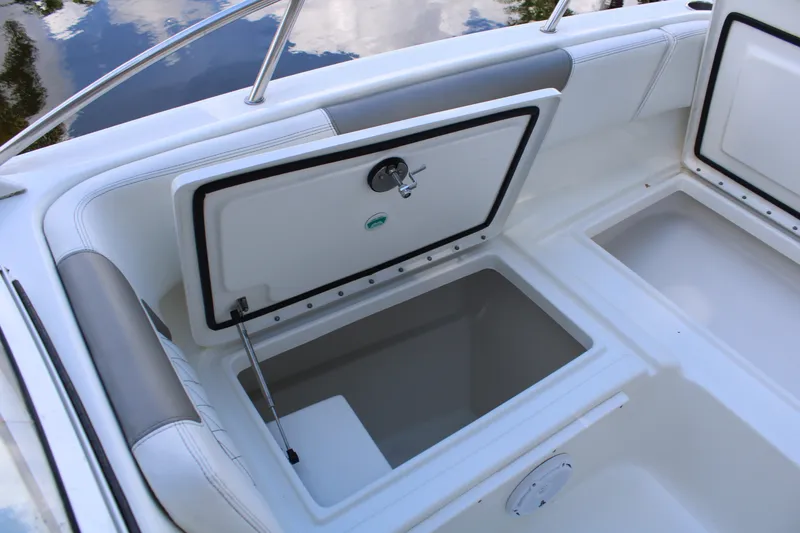 Slide: The Image of 2021 World Cat 255 DC boat storage compartment with open hatch, showcasing interior space. - 17