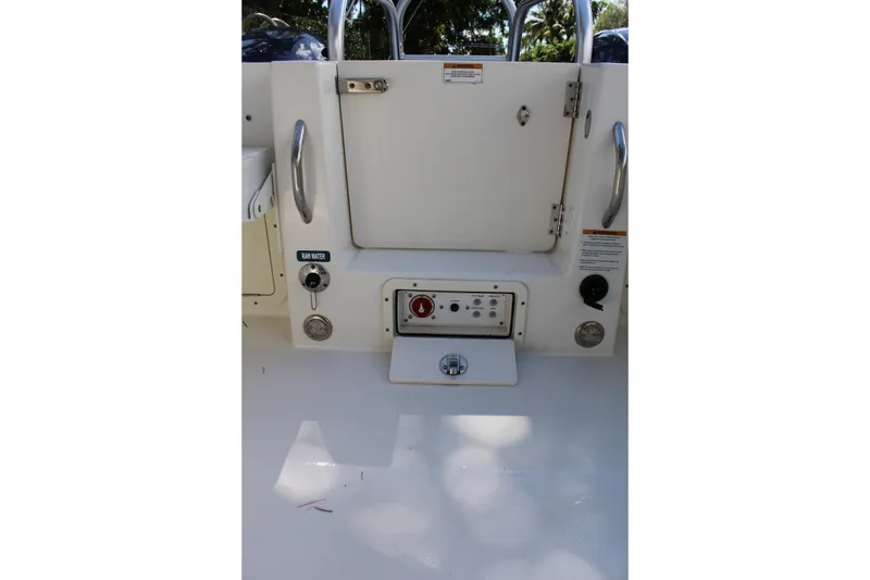 Slide: The Image of 2021 World Cat 255 DC boat interior with control panel and storage compartment. - 29