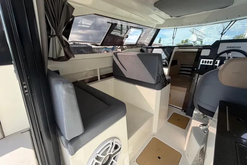 Slide: The Image of Interior of 2024 Sardine Marine 34 boat with seating, helm, and modern navigation equipment. - 13