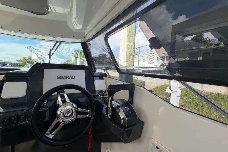 Slide: The Image of Interior view of 2024 Sardine Marine 34 boat cockpit with steering wheel and controls. - 29
