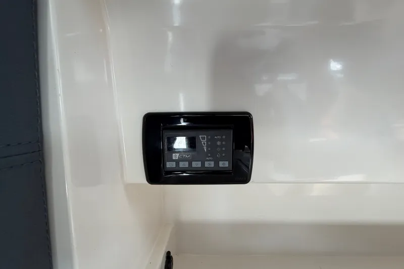 Slide: The Image of Control panel inside 2024 Sardine Marine 34 boat, featuring digital display and buttons. - 34