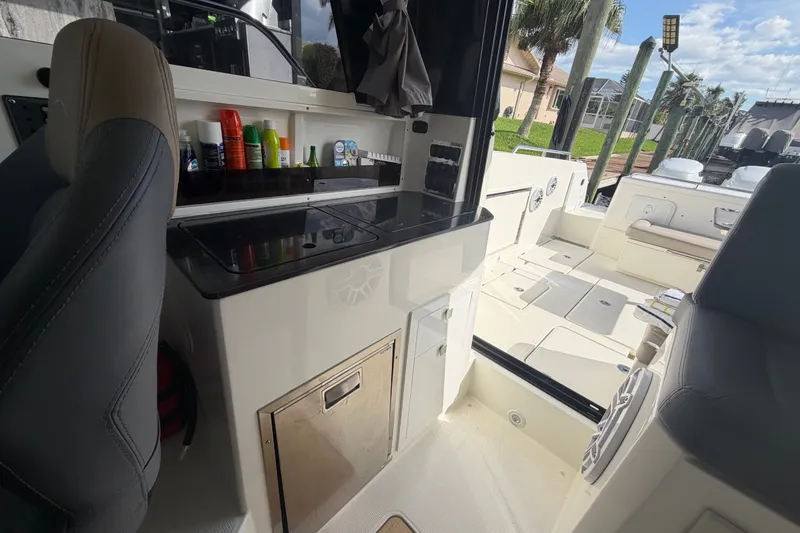 Slide: The Image of 2024 Sardine Marine 34 boat interior with seating, storage, and countertop amenities. - 24
