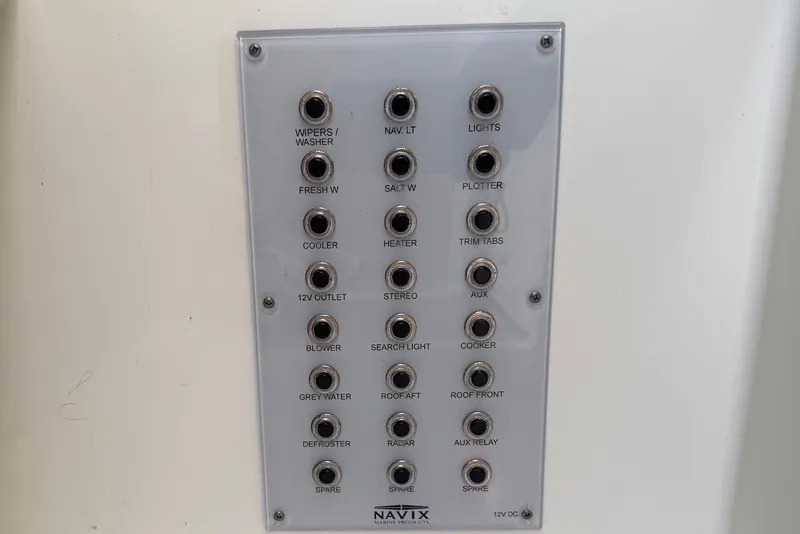 Slide: The Image of Control panel on 2024 Sardine Marine 34 boat with labeled switches for various functions. - 23