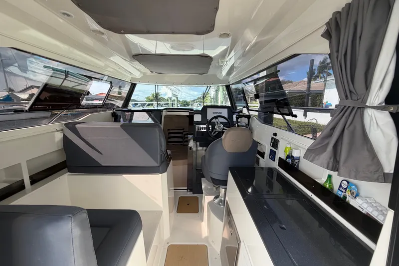 Slide: The Image of Interior of 2024 Sardine Marine 34 boat, featuring modern seating and navigation equipment. - 25