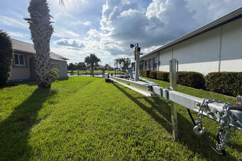 Slide: The Image of Boat trailer on grassy lawn, sunny day, Sardine Marine 34, 2024 model. - 42