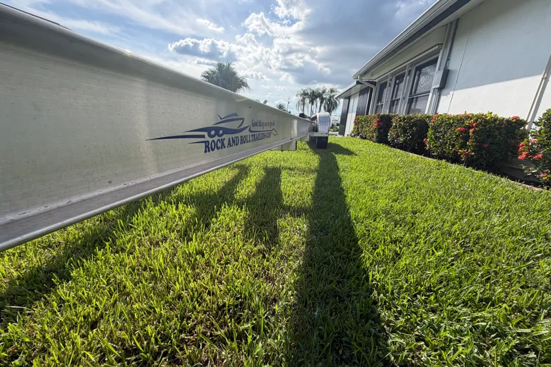 Slide: The Image of Trailer by Sardine Marine 34 (2024) on grass, near a house with bushes. - 41