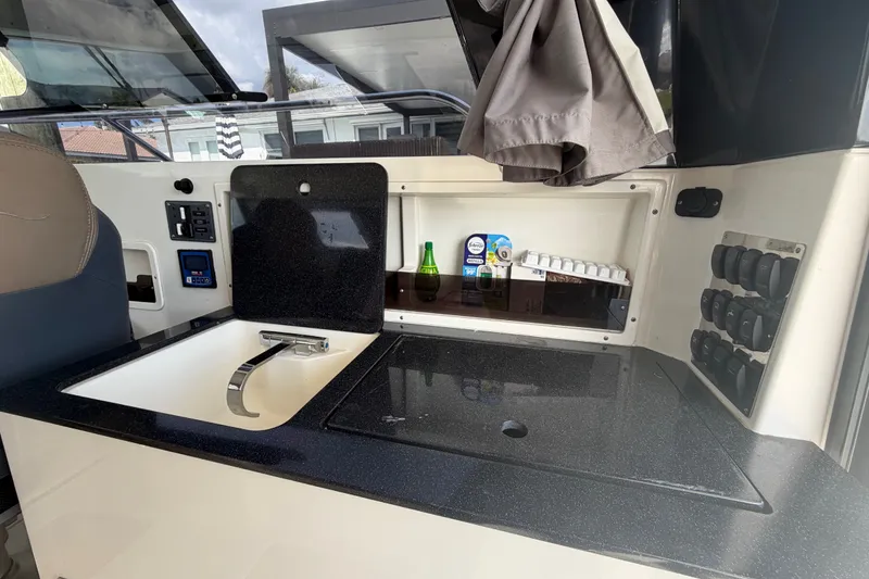 Slide: The Image of Interior of 2024 Sardine Marine 34 boat featuring a compact kitchen area with sink. - 27