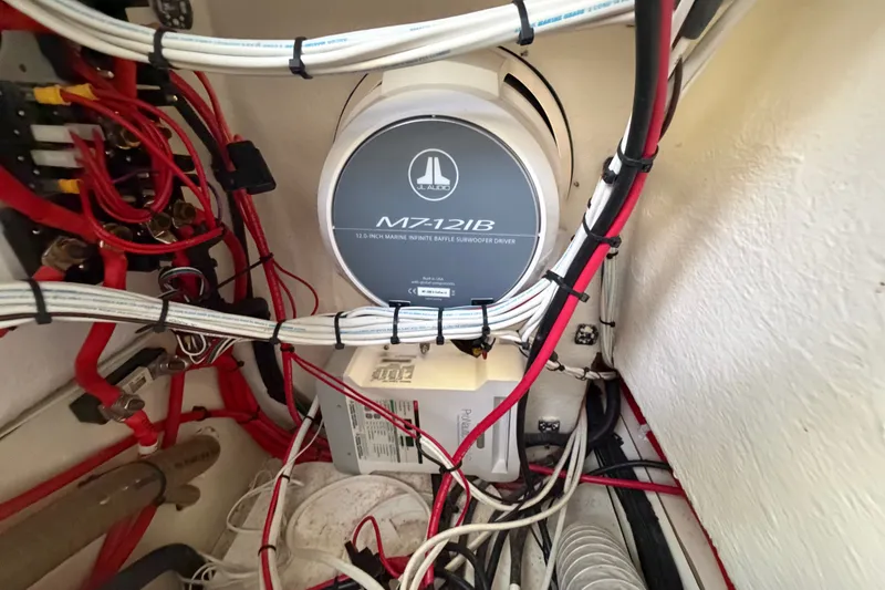 Slide: The Image of Marine subwoofer installation with wiring in a 2024 Sardine Marine 34 boat. - 19