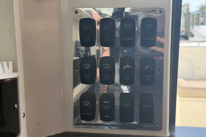 Slide: The Image of Control panel of a 2024 Sardine Marine 34 boat with various switches. - 22