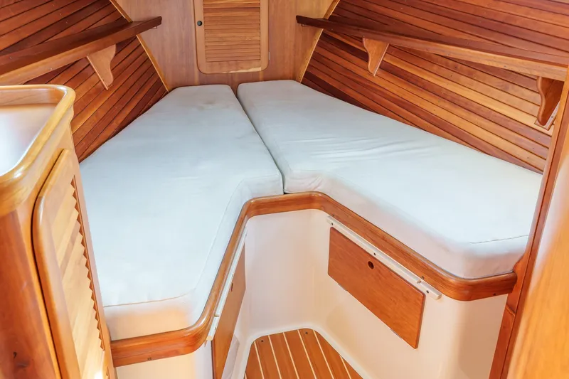 Slide: The Image of Interior cabin of 2001 Hinckley Picnic Boat 36 EP with wooden finish and white cushions. - 18