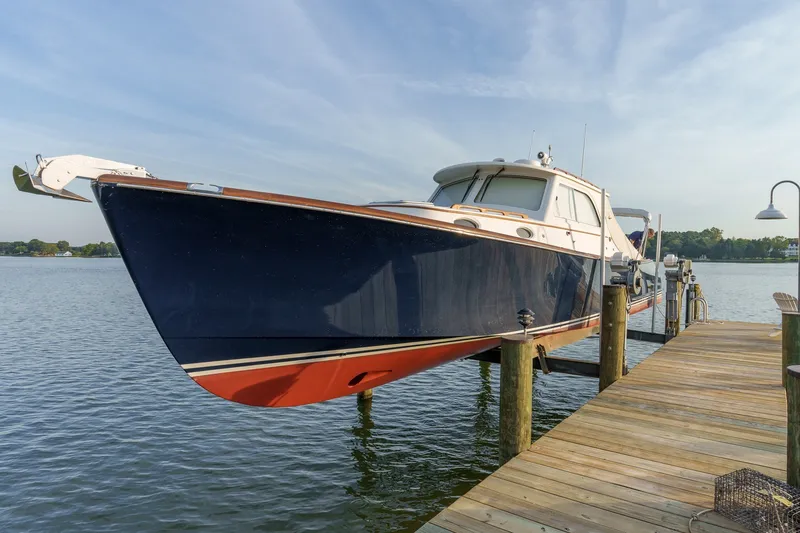 Slide: The Image of 2001 Hinckley Picnic Boat 36 EP docked on calm water. - 28