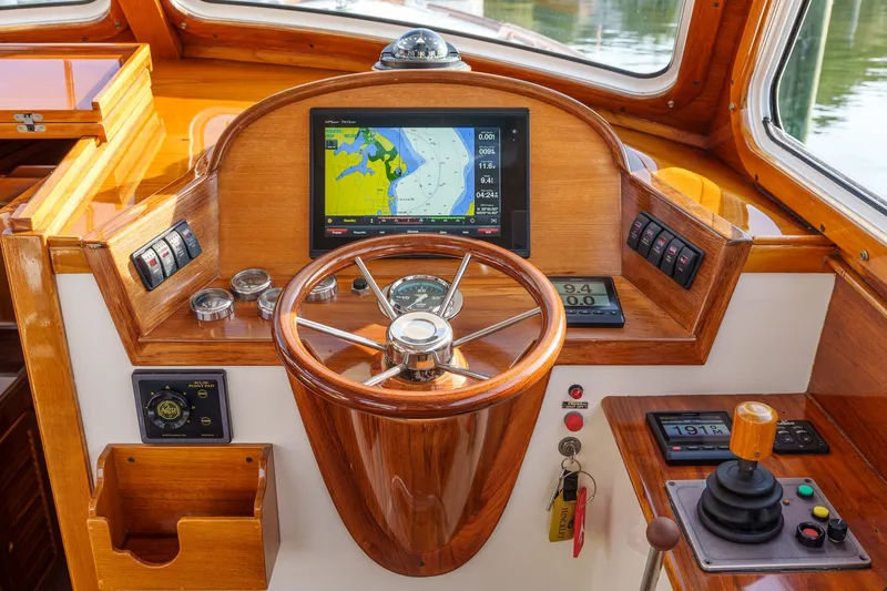 Slide: The Image of Helm of 2001 Hinckley Picnic Boat 36 EP with navigation display and wooden steering wheel. - 14