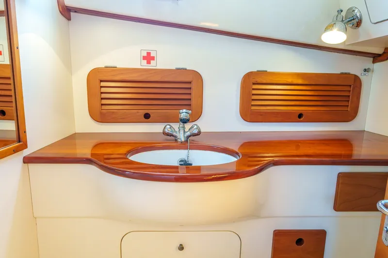 Slide: The Image of Elegant wooden sink area in 2001 Hinckley Picnic Boat 36 EP cabin. - 20
