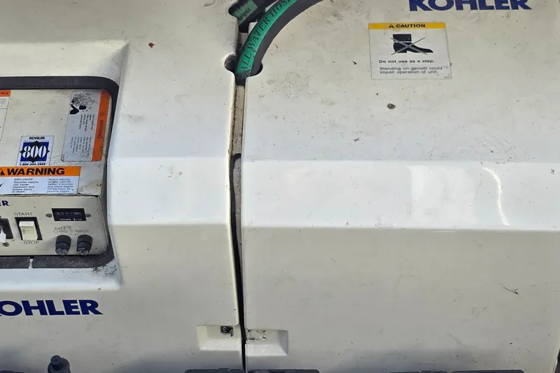 Slide: The Image of Kohler generator on a 1994 Mainship 40 Sedan Bridge, featuring caution and warning labels. - 36