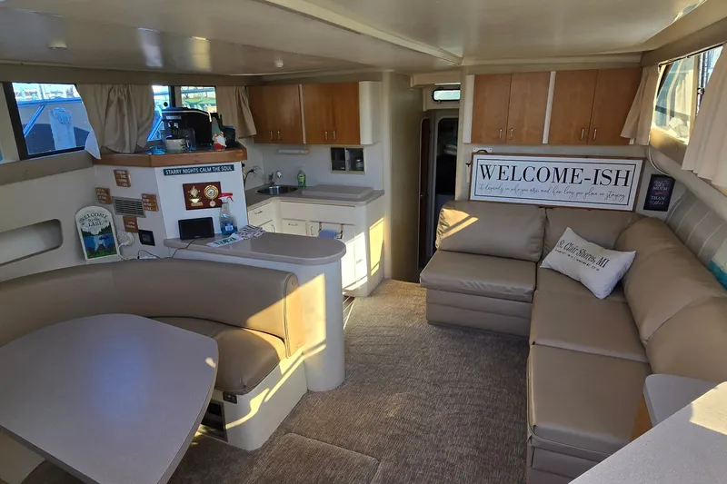 Slide: The Image of Interior of a 1994 Mainship 40 Sedan Bridge with cozy seating and kitchenette. - 15