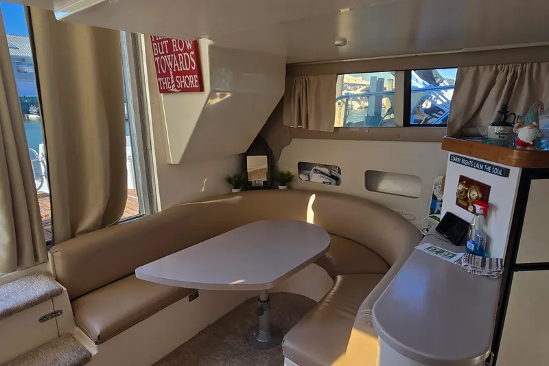 Slide: The Image of Interior of 1994 Mainship 40 Sedan Bridge with cozy seating and nautical decor. - 17