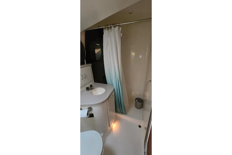 Slide: The Image of Bathroom interior of 1994 Mainship 40 Sedan Bridge with shower and sink. - 27