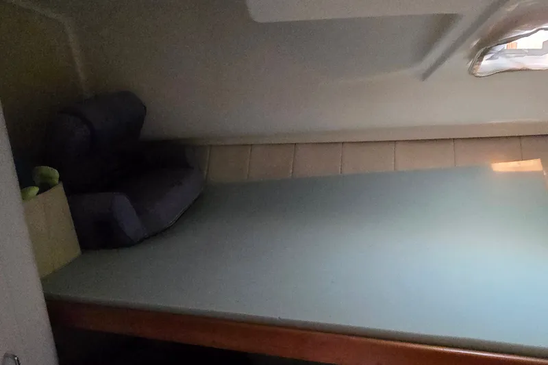 Slide: The Image of 1994 Mainship 40 Sedan Bridge interior cabin with bed and window view. - 29