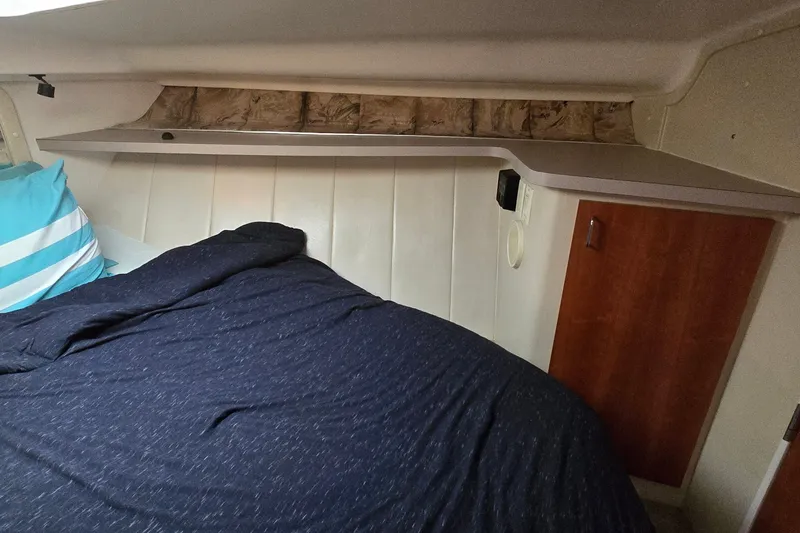 Slide: The Image of Cozy cabin interior of 1994 Mainship 40 Sedan Bridge with bed and wooden storage. - 25