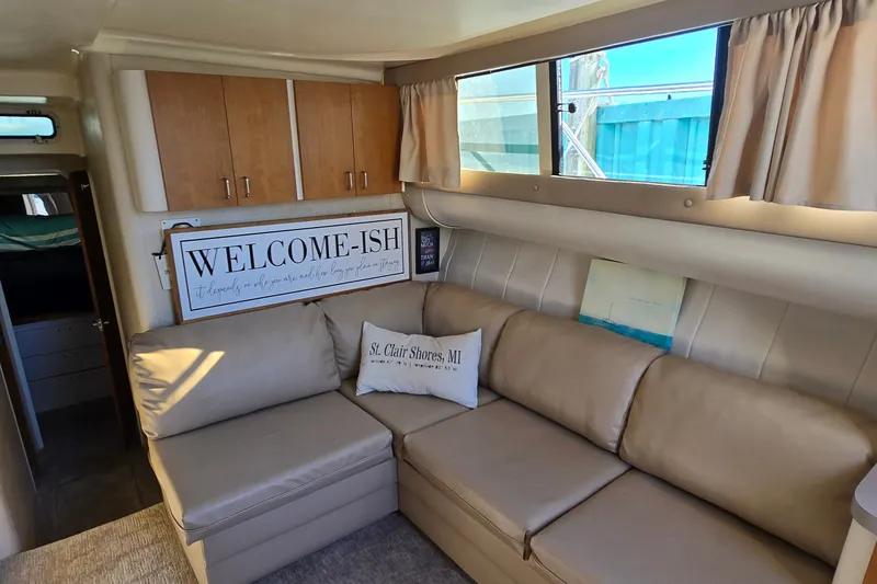 Slide: The Image of Interior of 1994 Mainship 40 Sedan Bridge with beige seating and decorative pillows. - 20
