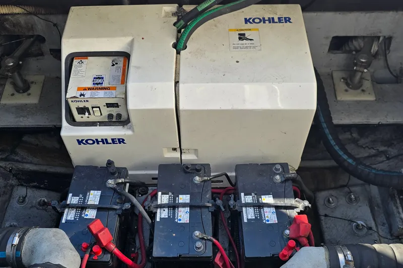Slide: The Image of Engine compartment of a 1994 Mainship 40 Sedan Bridge with Kohler generator and batteries. - 37