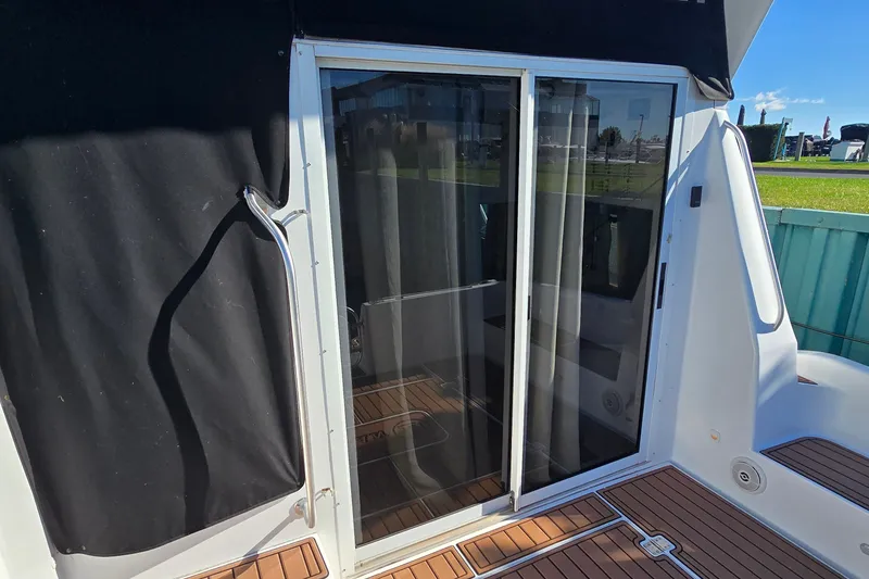 Slide: The Image of 1994 Mainship 40 Sedan Bridge with sliding glass door and teak deck. - 14