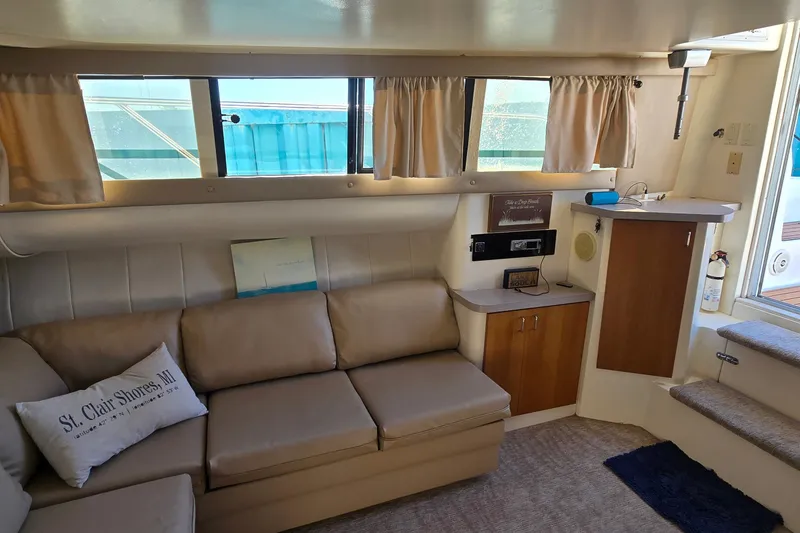 Slide: The Image of Interior of 1994 Mainship 40 Sedan Bridge with beige seating and nautical decor. - 19