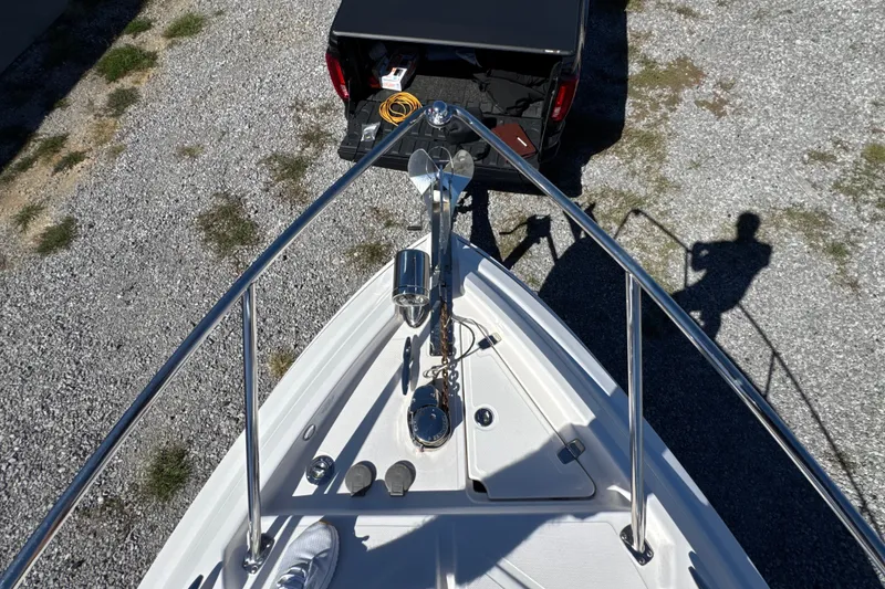 Slide: The Image of Bow view of 2017 Regal 28 Express boat with truck in background. - 53