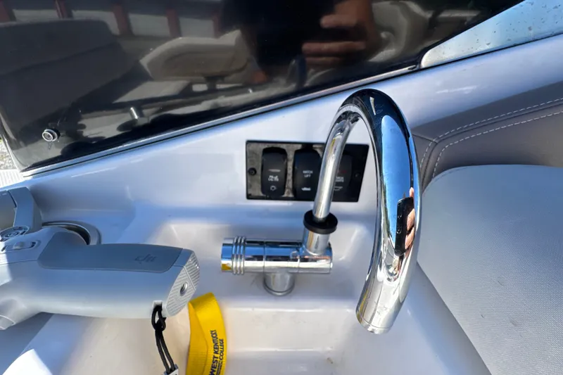 Slide: The Image of Control panel and faucet on 2017 Regal 28 Express boat. - 36