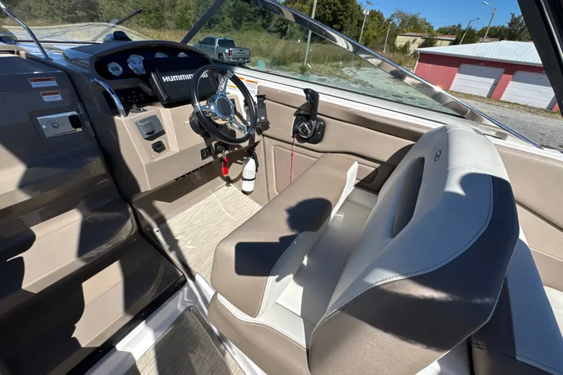 Slide: The Image of Interior of a 2017 Regal 28 Express boat, featuring steering wheel and dashboard controls. - 39