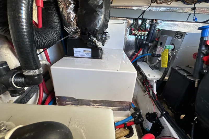 Slide: The Image of Engine compartment of a 2017 Regal 28 Express boat, showcasing wiring and components. - 66