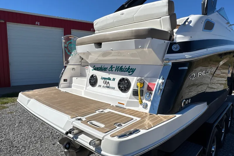 Slide: The Image of 2017 Regal 28 Express boat with custom name "Sunshine & Whiskey" at dockside. - 9