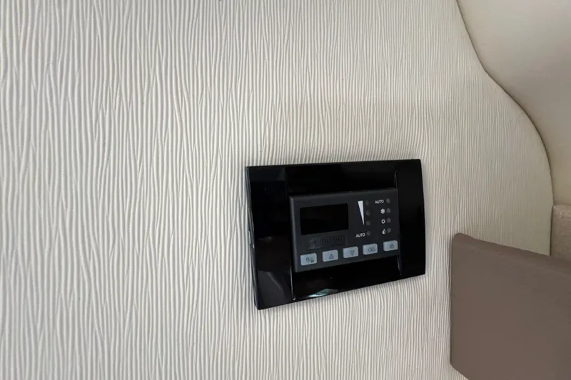 Slide: The Image of Control panel on 2017 Regal 28 Express boat's textured interior wall. - 95