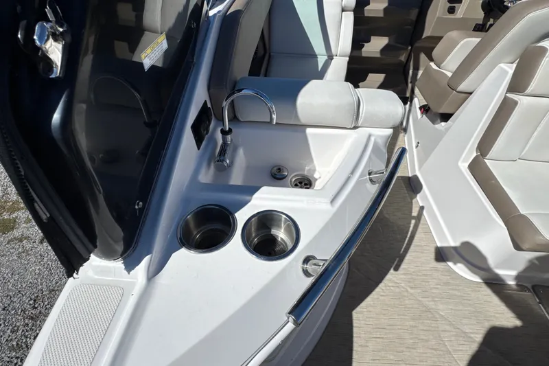 Slide: The Image of Interior of 2017 Regal 28 Express boat featuring sink and cup holders. - 30
