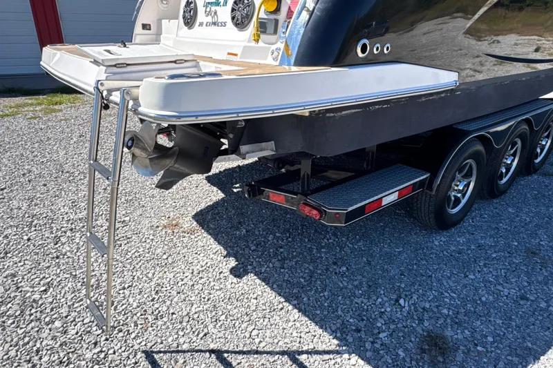 Slide: The Image of 2017 Regal 28 Express boat on trailer with ladder and propeller visible. - 11