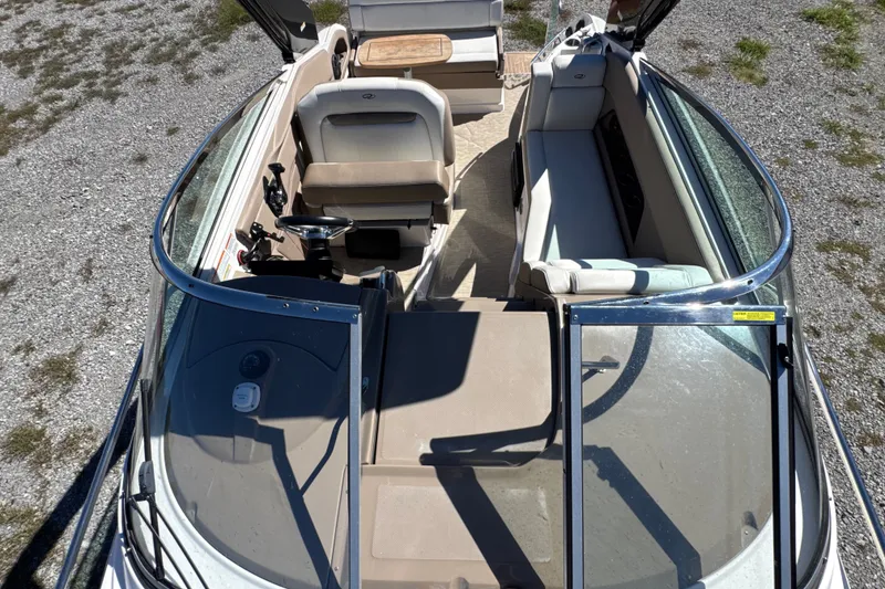 Slide: The Image of 2017 Regal 28 Express boat interior with seating and steering wheel, viewed from above. - 60