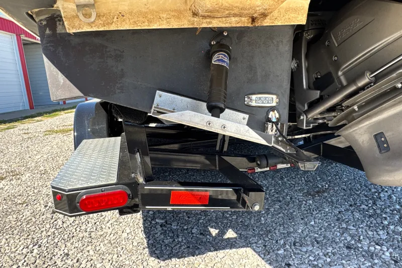 Slide: The Image of Rear view of a 2017 Regal 28 Express boat on a trailer, showing engine and propeller. - 10