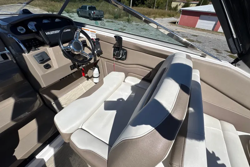 Slide: The Image of Interior of 2017 Regal 28 Express boat with steering wheel and seating. - 41