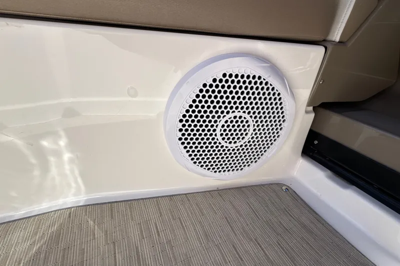Slide: The Image of Speaker on 2017 Regal 28 Express boat interior, featuring beige and white design. - 38