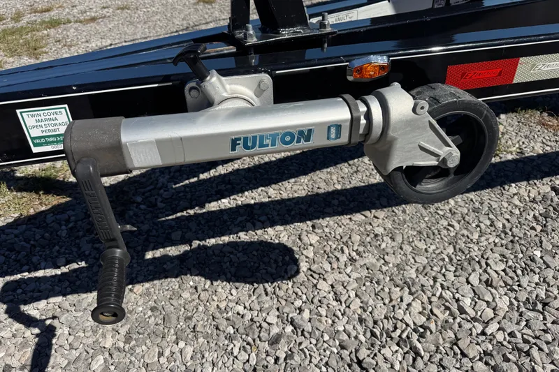 Slide: The Image of Trailer jack with Fulton branding on a 2017 Regal 28 Express boat trailer. - 101