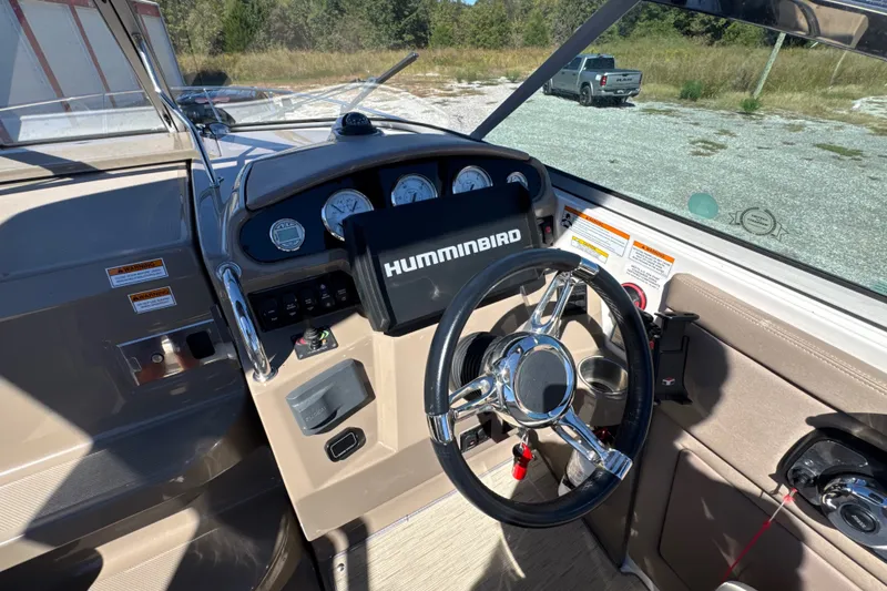 Slide: The Image of 2017 Regal 28 Express boat dashboard with steering wheel and Humminbird navigation system. - 42